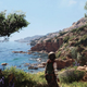 a child stares at the sea on a sunny day in a plague tale requiem